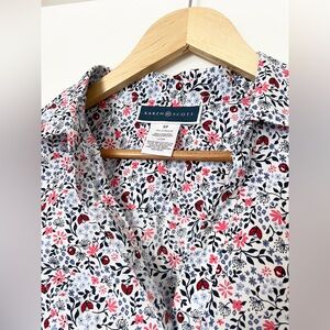 Adorable floral and butterfly print short sleeve button up blouse.